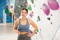 Sports positive woman climber on background of climbing wall