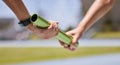 Sports, running and hands of runner with baton for exercise, fitness and speed at stadium. Sport, hand and team relay Royalty Free Stock Photo