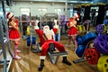 Sports Santa Claus with girls in Santa`s costumes in the gym on