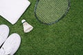 Sports set of blue sport shoes and shuttlecocks with badminton racket on grass background in concept family activity Royalty Free Stock Photo