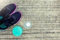 Sports shoes with bottle and green color dumbbell on the floor o Royalty Free Stock Photo