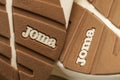Sports shoes of the Joma brand. Rubber sole. Logo close-up
