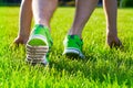 Sports shoes sneakers on a fresh green grass field. Royalty Free Stock Photo