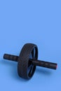 Sports simulator roller for press on blue background.