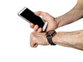 Sports smart watch on athlete`s hand and smartphone Royalty Free Stock Photo