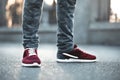 Sports  sneakers close-up on asphalt. Legs and shoes from the lower angle Royalty Free Stock Photo