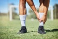 Sports, soccer and ankle injury on grass with self assessment of physical pain at athlete game. Hurt, injured and joint