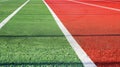 A sports stadium featuring red artificial rubber running tracks with white lines Royalty Free Stock Photo