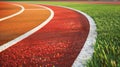 A sports stadium featuring red artificial rubber running tracks with white lines Royalty Free Stock Photo