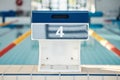 Sports, swimming and podium number by pool for training, exercise and workout for triathlon competition. Fitness