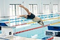Sports, swimming pool and man diving in water for training, exercise and workout for competition. Fitness, wellness and Royalty Free Stock Photo