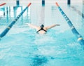 Sports, swimming pool and woman athlete training for a race, competition or tournament. Fitness, workout and back of Royalty Free Stock Photo
