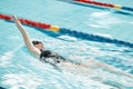 Sports, swimming pool and woman swimmer training for a race, competition or tournament. Fitness, workout and female Royalty Free Stock Photo