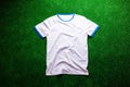 Sports t-shirt against artificial turf. Studio shot. Copy space. Royalty Free Stock Photo