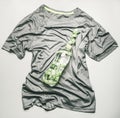 Sports t-shirt for jogging and training in the gym, on which lies a bottle of water with measuring tape, the concept of a sport l