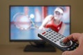 Sports television remote control in the hand, zapping Royalty Free Stock Photo