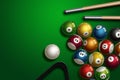 Sports theme with billiards, a full set of billiard balls, cue, on a green background. top view, flat lay, copy space, snooker. Royalty Free Stock Photo