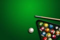 Sports theme with billiards, a full set of billiard balls, cue, on a green background. top view, flat lay, copy space, snooker.