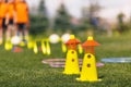 Sports training tools. Soccer equipment on pitch. Yellow and red practice cones on sports field Royalty Free Stock Photo