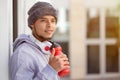 Sports training young latin man drinking water looking up thinking runner copyspace copy space Royalty Free Stock Photo