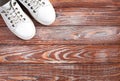 Sports white sneakers on wooden background. Fitness concept. Concept healthy lifestyle. Top view. Copy space Royalty Free Stock Photo