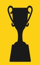 A sports winning prize trophy silhouette against a yellow backdrop Royalty Free Stock Photo