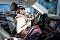 Sports woman driving a car Royalty Free Stock Photo