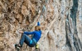 sports woman rock climber climbing on cliff, focused on difficult route and next move Royalty Free Stock Photo