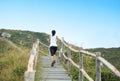 Sports woman running on mountain stairs Royalty Free Stock Photo
