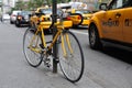 Yellow bike and yellow taxicabs