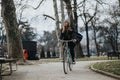 Sports young woman enjoying a peaceful bike ride in a city park. Royalty Free Stock Photo