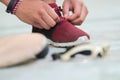 Sportsman adjusting shoelace beside eyewear bat and ball