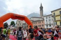 Sportsman arriving at the finish of `Lecco city - Resegone mountain` running marathon event.