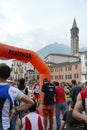 Sportsman arriving at the finish of `Lecco city - Resegone mountain` running marathon event.