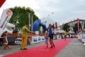 Sportsman arriving at the finish of `Lecco city - Resegone mountain` running marathon event.