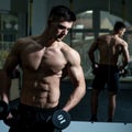 Sportsman, athlete with muscles looks attractive. Man with torso, muscular macho and his reflexion in mirror background Royalty Free Stock Photo