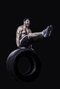 Sportsman balancing on a tire isolated