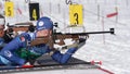 Sportsman biathlete aiming, rifle shooting, reloading rifle in prone position. Biathlete Smolyakov Danila in shooting
