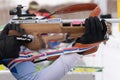 Sportsman biathlete aims rifle shooting. Selective focus, extreme close-up shot. Biathlete in shooting range