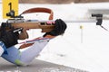 Sportsman biathlete aims rifle shooting. Selective focus, extreme close-up shot. Biathlete in shooting range