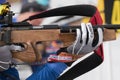 Sportsman biathlete aims rifle shooting. Selective focus, extreme close-up view shot. Biathlete in shooting range