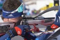 Sportsman biathlete rifle shooting, aiming, reloading rifle in prone position. Biathlete Amirbekov Artem in shooting range. Junior