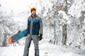 Sportsman with board in snowy nature