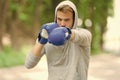 Sportsman concentrated training boxing gloves. Athlete concentrated face sport gloves practice fighting skills nature