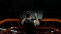 sportsman do pullup workout with pegboard in sport gym. sportsman pullup in gym with pegboard.