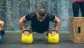 Sportsman doing push-ups with kettlebells Royalty Free Stock Photo