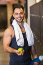 sportsman eating apple after training in lockerroom Royalty Free Stock Photo