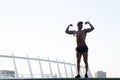 Sportsman flexing arms on roof