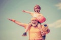 Sportsman grandfather and healthy kid with basketball ball on blue sky background. Sport for little children. Different