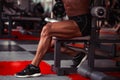 Sportsman in gym. Guy doing exercises. Closeup portrait of legs with veins. Male model with tanned skin. man Royalty Free Stock Photo